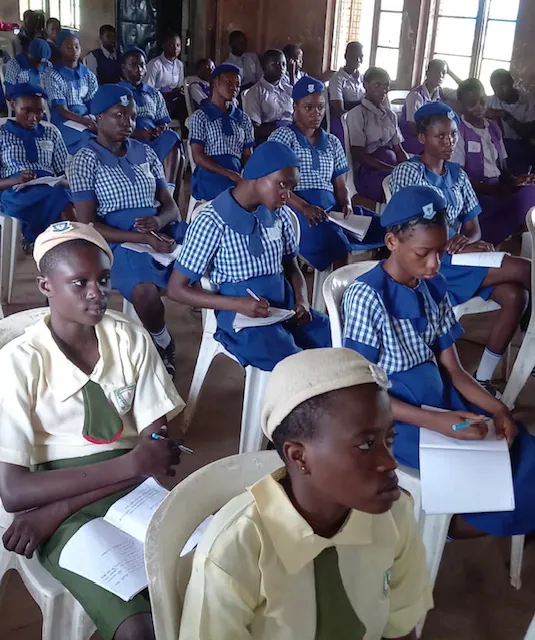 Girls taking notes during an ICT workshop