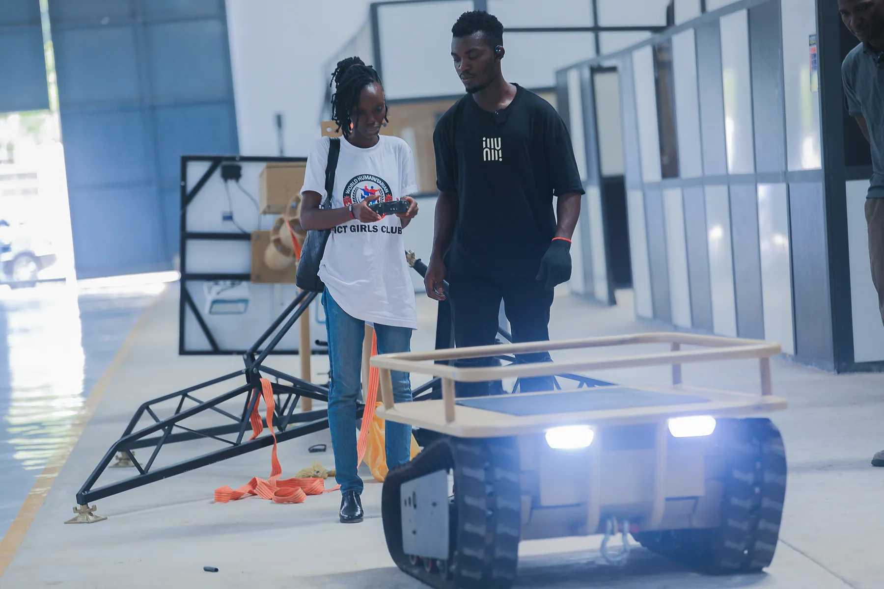 Girl using a controller to operate a mobile robot