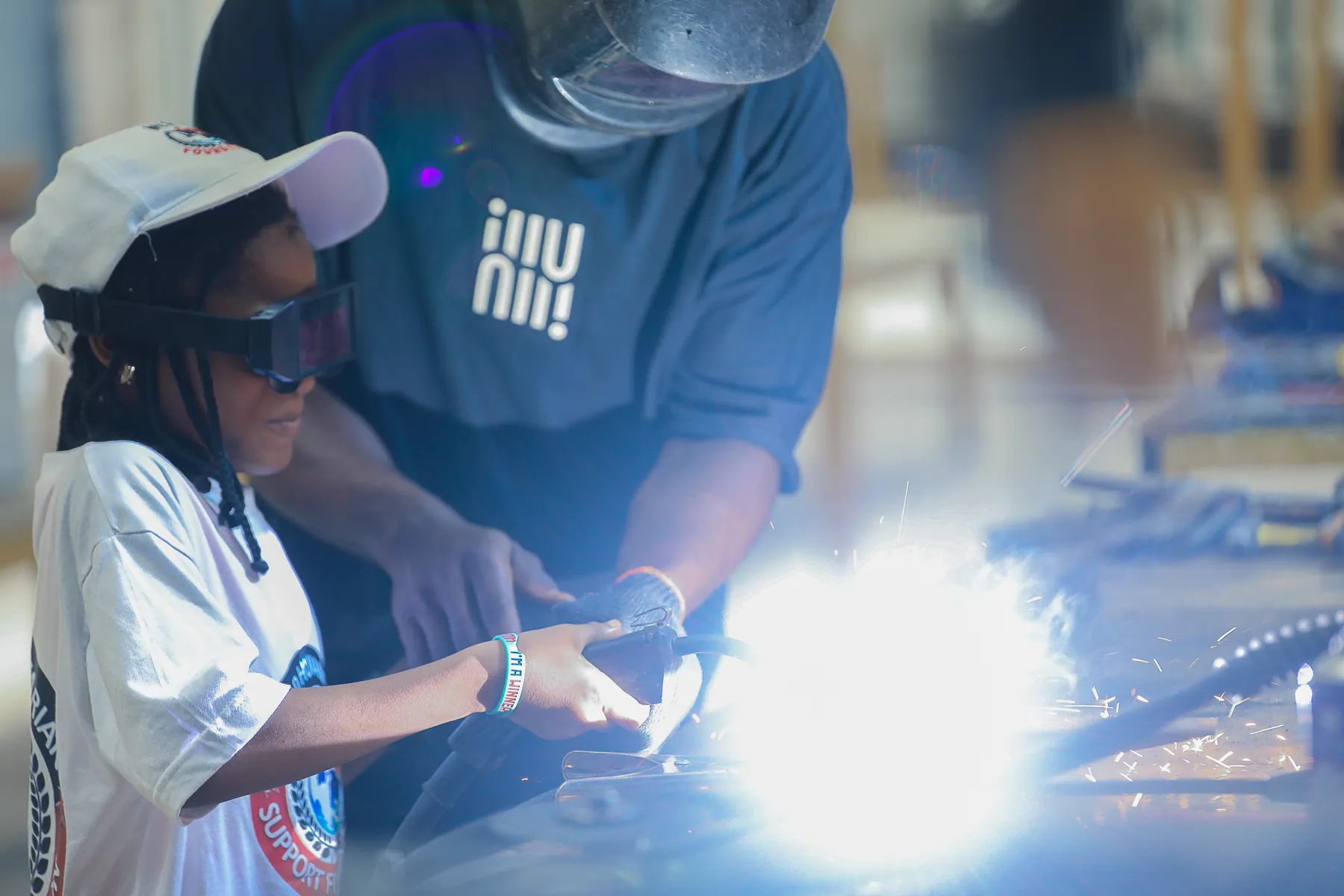 Participant safely trying supervised welding for the first time